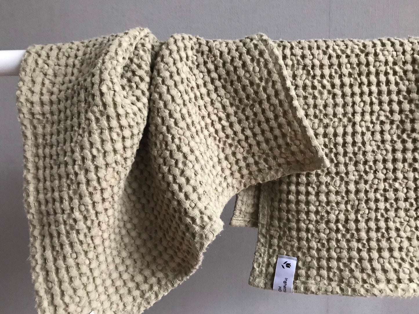 Fingertip face waffle linen towel. Olive green